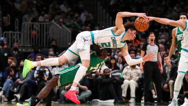 Jan 19, 2022; Boston, Massachusetts, USA; Boston Celtics guard Dennis Schroder (71) fouls Charlotte Hornets guard LaMelo Ball (2) during the second half at TD Garden. Mandatory Credit: Paul Rutherford-USA TODAY Sports